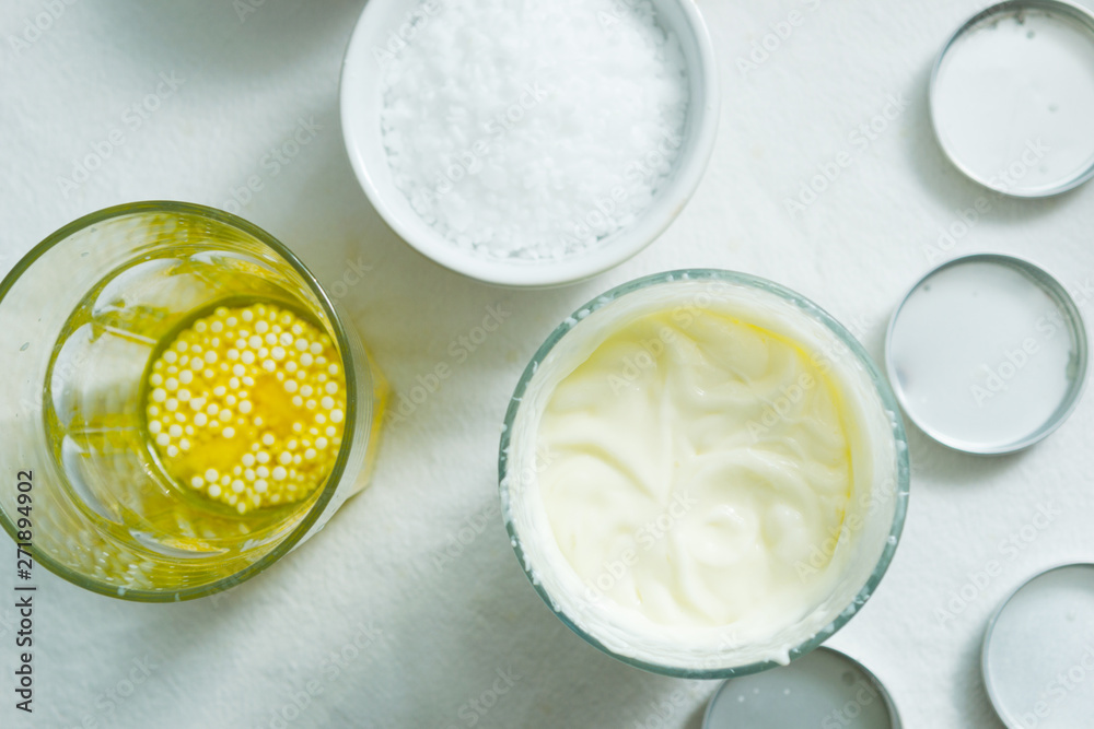 cosmetic lotion cream diy do it yourself ingredients creamer arrangement on white textile cloth top view cosmetic lotion cream diy do it yourself ingredients creamer arrangement on white textile cloth top view