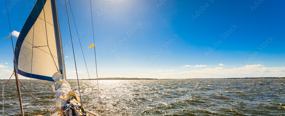 Yachting on sail boat during sunny weather - obrazy, fototapety, plakaty 