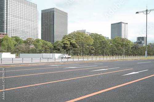 A group building with tree and road in a modern city in Tokyo. - Image