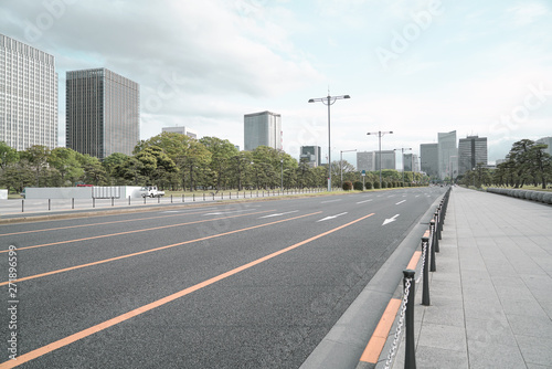 A group building with tree and road in a modern city in Tokyo. - Image