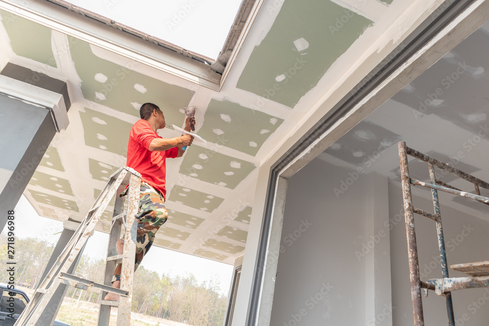 Construction worker are plastered a ceiling. Concept build a house