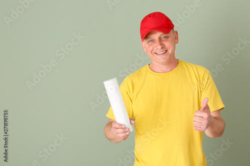 Handsome plumber showing th...