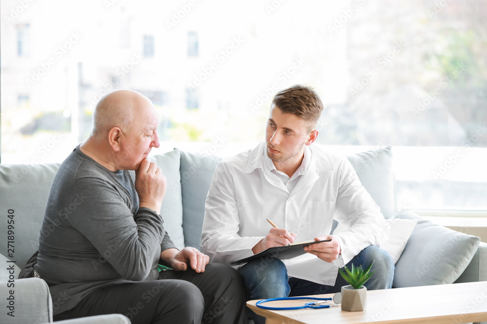 Doctor examining senior man in nursing home Doctor examining senior man in nursing home