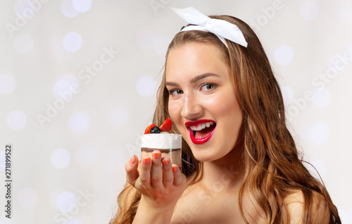 Young girl smiling with cupcake in hand