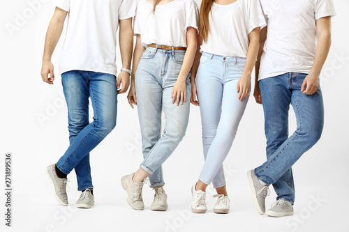 Stylish young people in jeans on white background