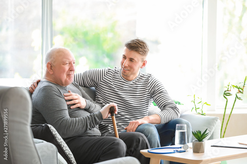 Male caregiver with senior ...