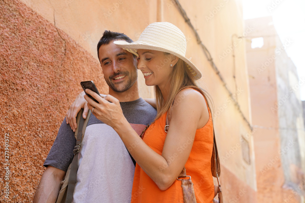 Couple taking selfie in side street in Marrakech Couple taking selfie in side street in Marrakech