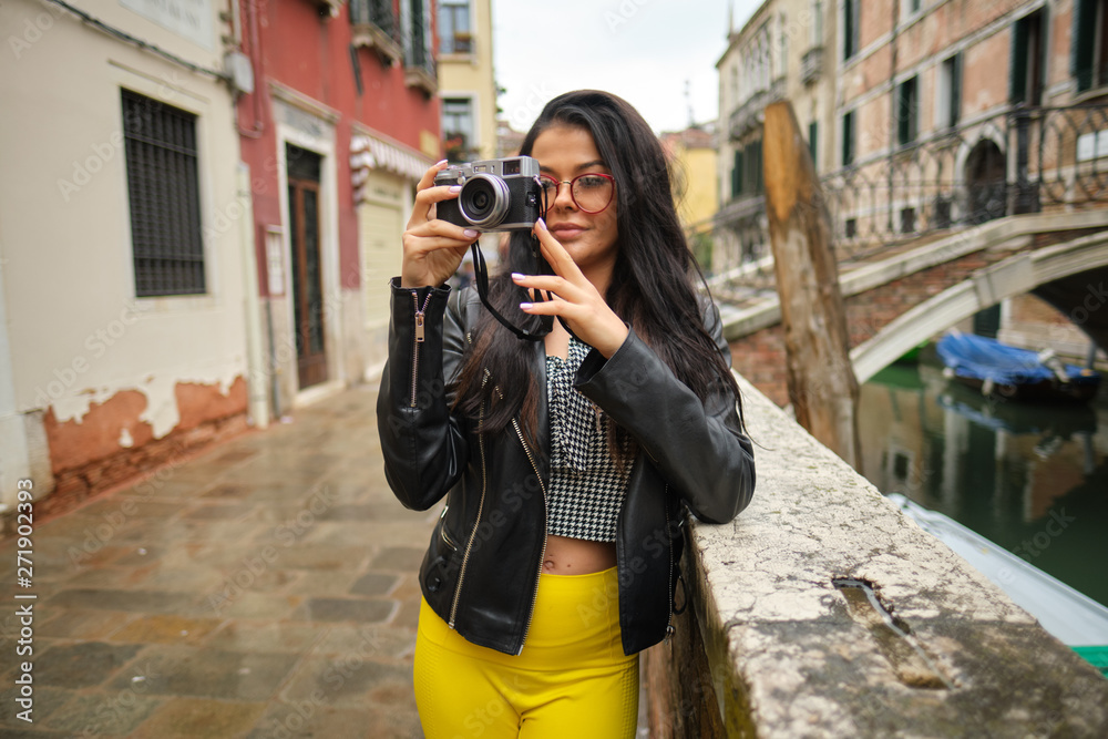 Travel photographer woman with camera in Venice, Italy.
