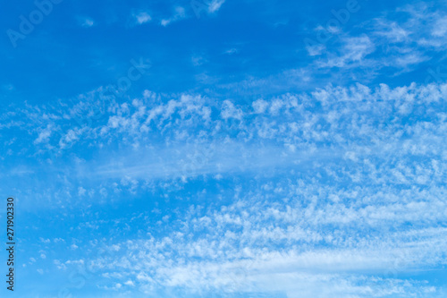 Blue sky with picturesque fluffy clouds background