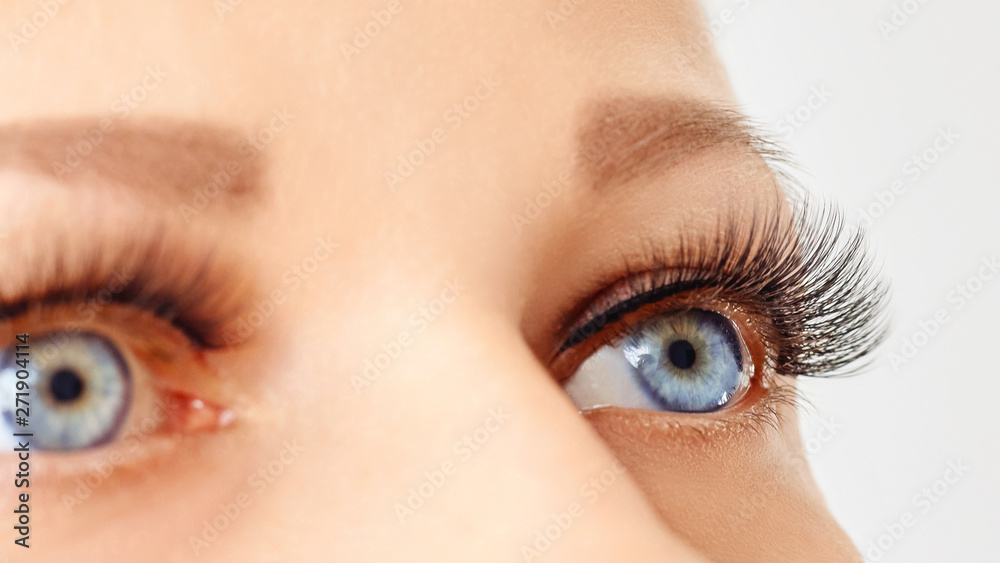 Female eyes with long false lashes. Eyelash extensions, make-up, cosmetics, beauty