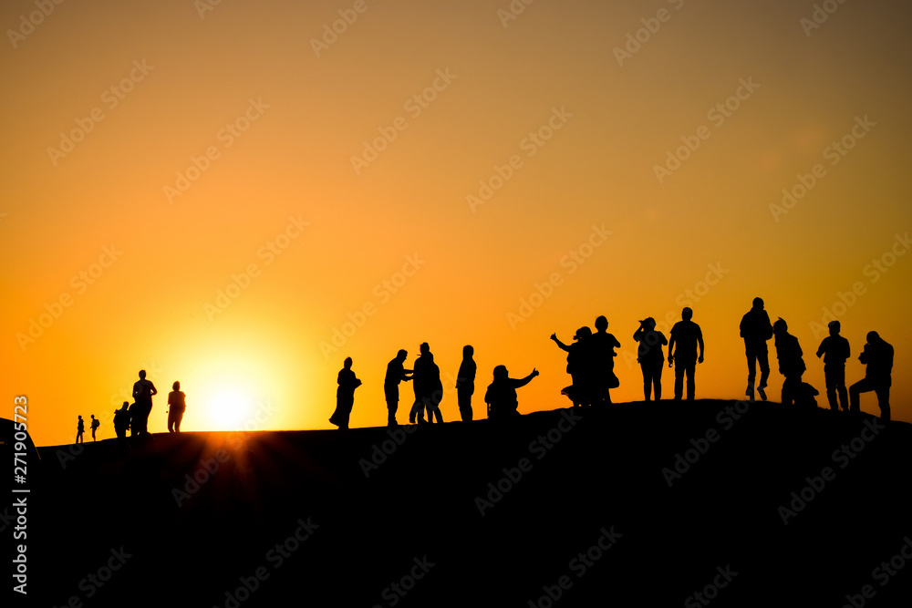 Silhouettes at sunset in the Arabian desert 