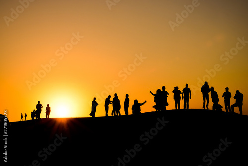 Silhouettes at sunset in the Arabian desert 