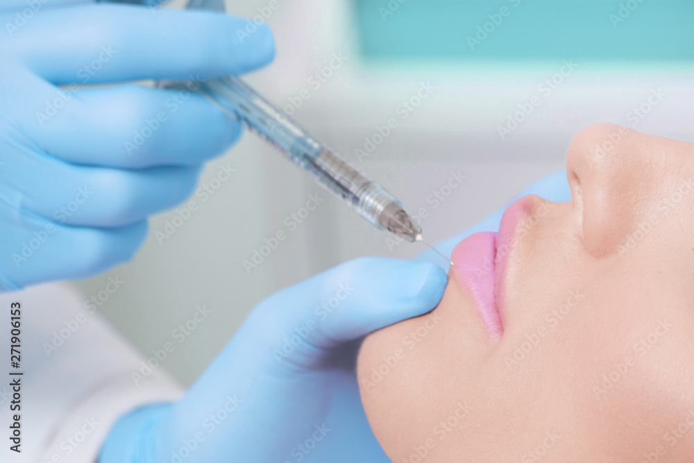 closeup of woman lips increase volume with injection hyaluronic filler in medical clinic closeup of woman lips increase volume with injection hyaluronic filler in medical clinic