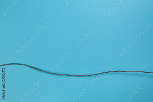 Black power cable socket on blue background