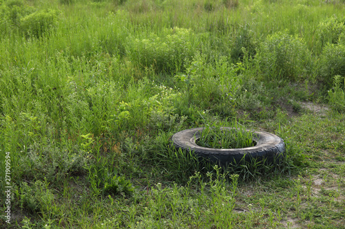 Landscape view on a green forest and grass with huge garbage dump. Nature pollution concept