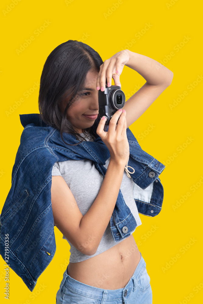 Girl holding compact camera in hands and take photo. Girl holding compact camera in hands and take photo.
