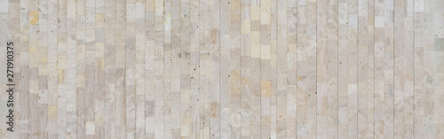 Background texture of old beige marble wall from a variety of large tiles