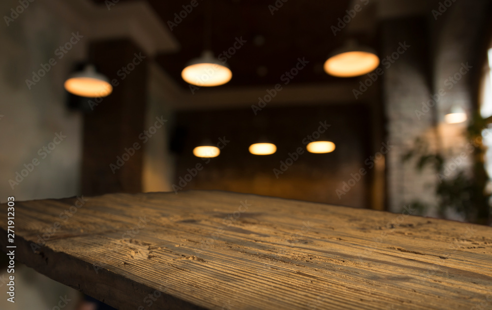 Wood table top with reflect on blur of lighting in night cafe Wood table top with reflect on blur of lighting in night cafe