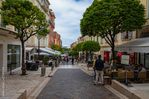 Fototapeta Naklejka Na Ścianę i Meble -  People walking through a narrow street in the center of Monaco on the French Riviera.