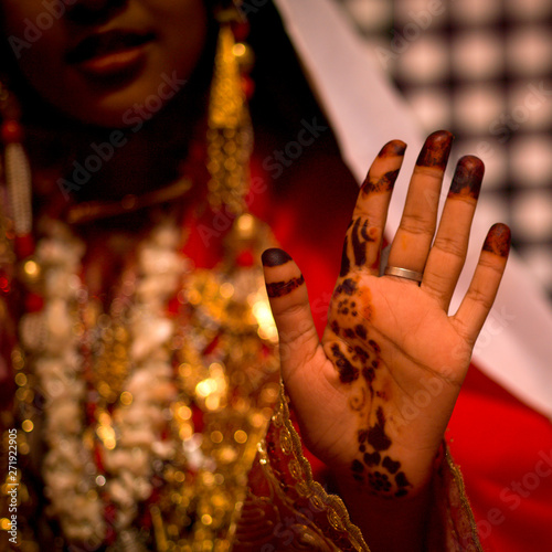 Tuareg girl in traditional dress showing her hand with henna, Ghadames,  Libya photo