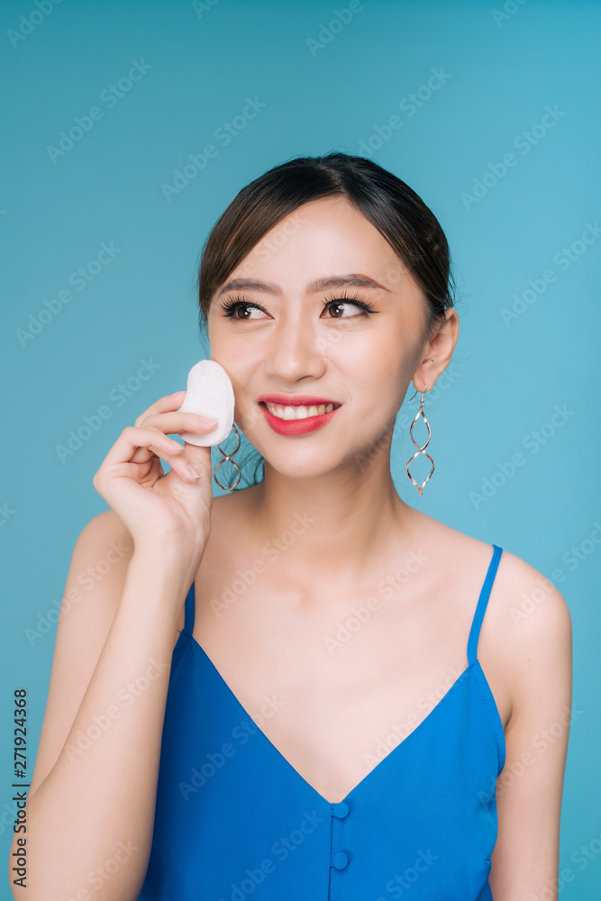 Woman using cotton pad. Happy smiling beautiful young woman cleaning skin by cotton pad. Woman using cotton pad. Happy smiling beautiful young woman cleaning skin by cotton pad.
