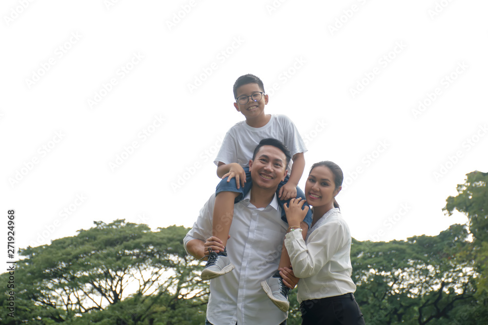 Happy family .Boy sitting on shoulders of father Happy family .Boy sitting on shoulders of father
