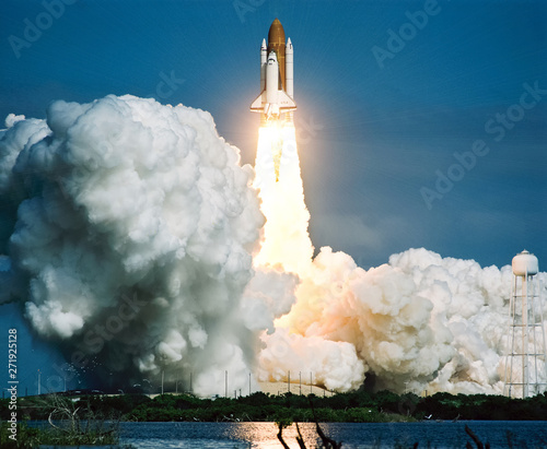 Rocket takes off into the sky. Lots of smoke and gas. The elements of this image furnished by NASA.