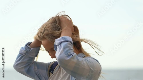 Happy blode woman outdoors. Waving blonde hair, smiling. photo