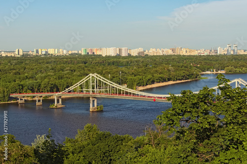 Aerial landscape view of River Dnipro with Pedestrian bridge. It connects the central part of Kyiv with the park area and the beaches of Trukhanov Island. Built in 1956-1957