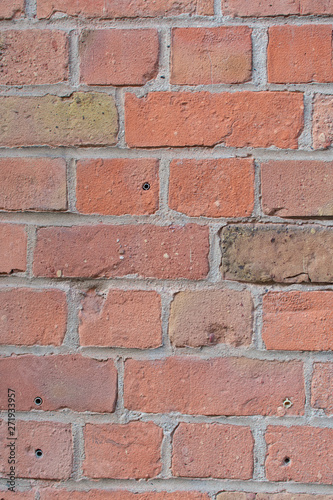 Closeup of dirty washed out red brown brick wall texture