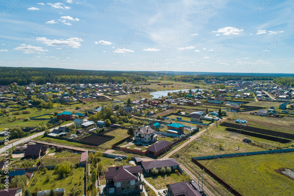 Shaidurovo village with small pond. Summer, sunny day. Aerial