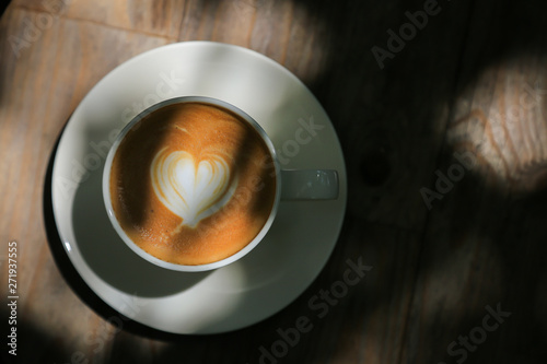 Latte coffee on low light wood floors Natural light for design or background work
