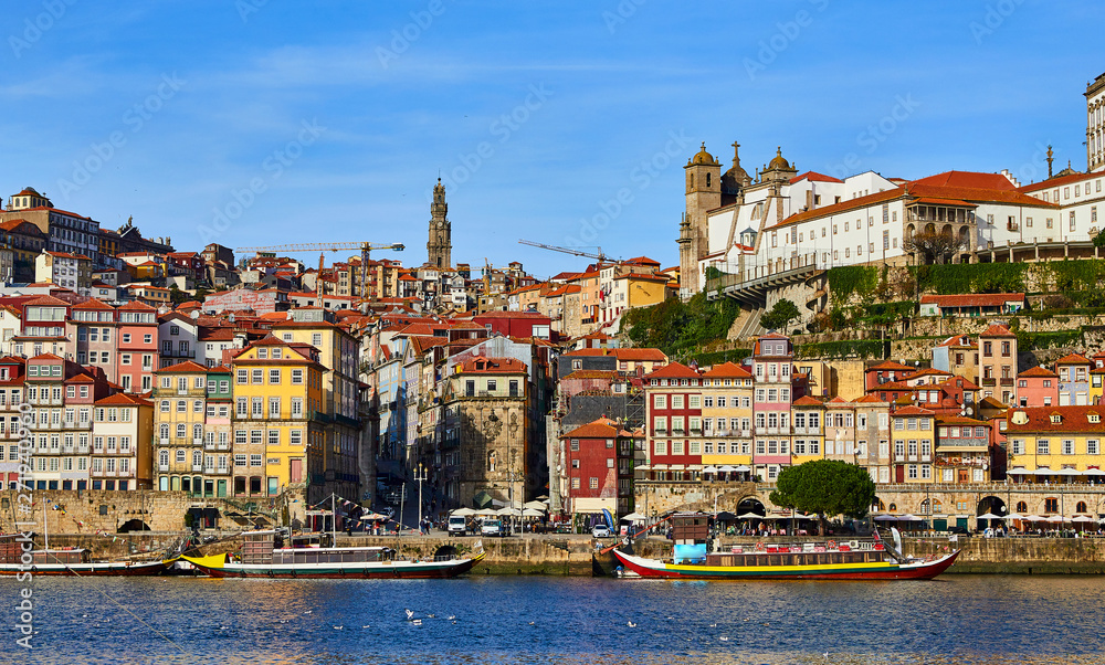 Portugal, Porto old town ribeira aerial promenade view with colorful houses, Douro river and boats.Concept of world travel, sightseeing and tourism