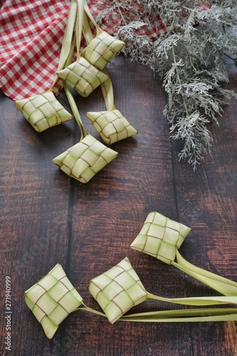 Ketupat (Rice Dumpling) On Wooden Background. Ketupat is a natural rice casing made from young coconut leaves for cooking rice during eid Mubarak, Fitri 