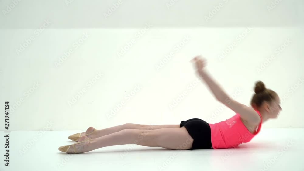 The gymnast perform an acrobatic element on the floor. The gymnast perform an acrobatic element on the floor.