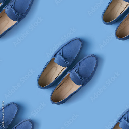 Seamless pattern of blue suede man's mocassin shoes over blue background