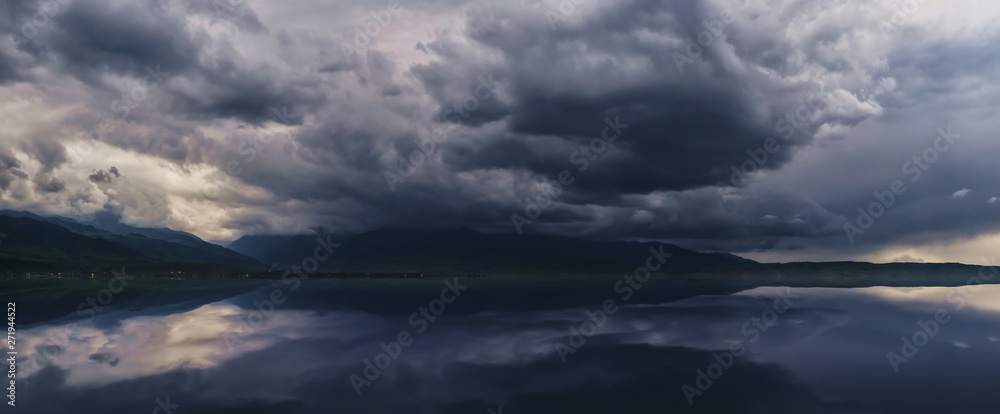 Fototapeta premium Amazing cloud over the mountains. dramatic storm over the lake and mountains. Adventure for hiking, climbing and other outdoor sports