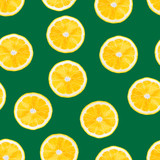 Lemons slice on green background. Summer fruits seamless pattern. Lemon texture design for textiles, wallpaper, fabric.