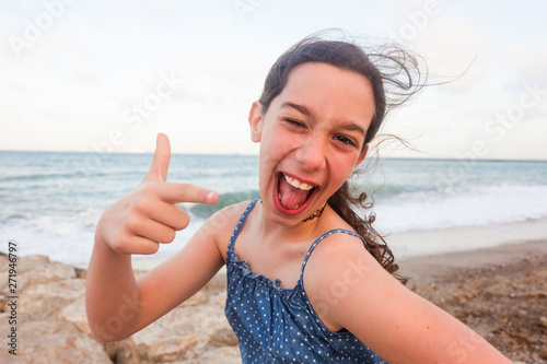 Teen making faces and sticking out her tongue