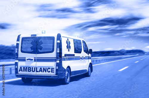 Ambulance van on highway with flashing lights