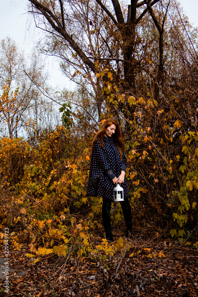 young redhead woman with white lamp in the hand in autumn park young redhead woman with white lamp in the hand in autumn park