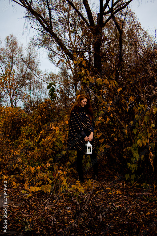 young redhead woman with white lamp in the hand in autumn park young redhead woman with white lamp in the hand in autumn park
