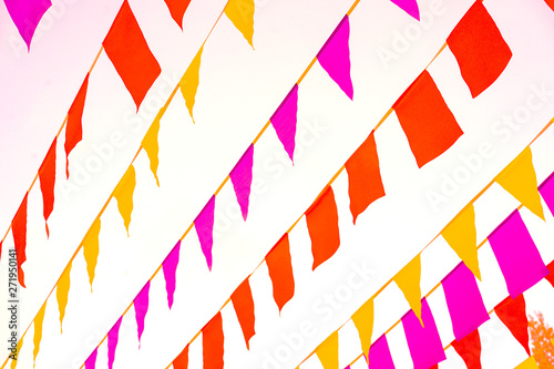 Fototapeta Naklejka Na Ścianę i Meble -  Bright colored paper pennons on the lines fluttering on the wind. Pennant flag strings.