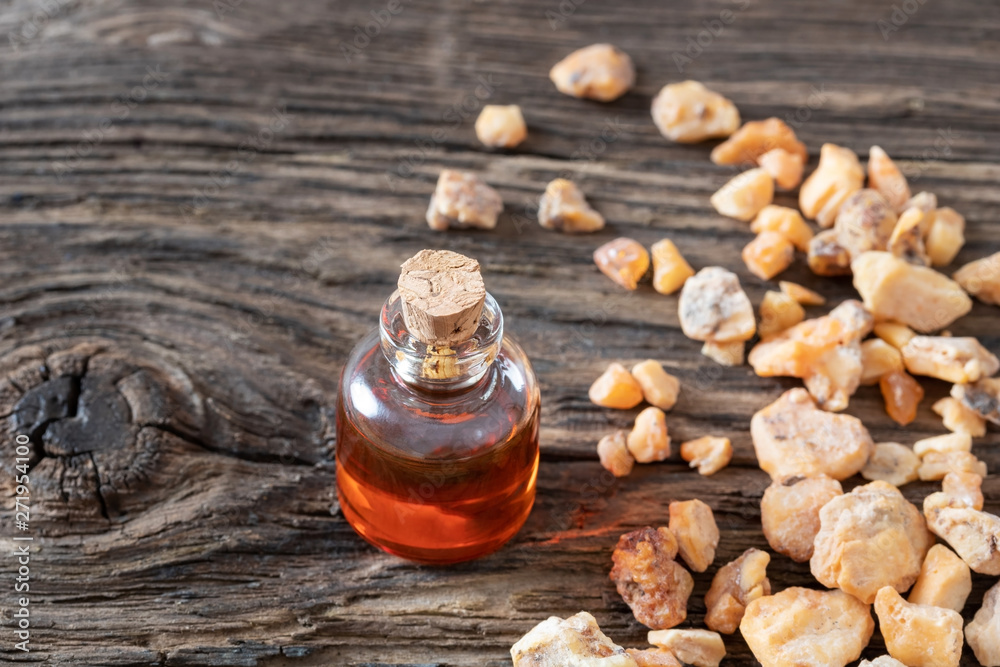 A bottle of styrax benzoin essential oil with benzoin resin Stock Photo |  Adobe Stock