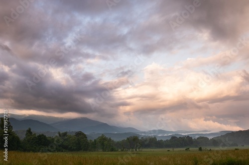 Sunrise and beautiful clouds over a mountain range in the distance. 