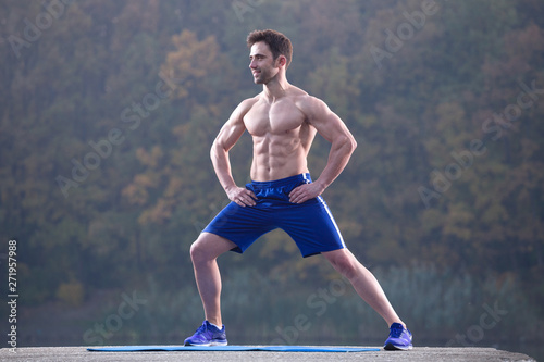 Fitness man front pose outdoor