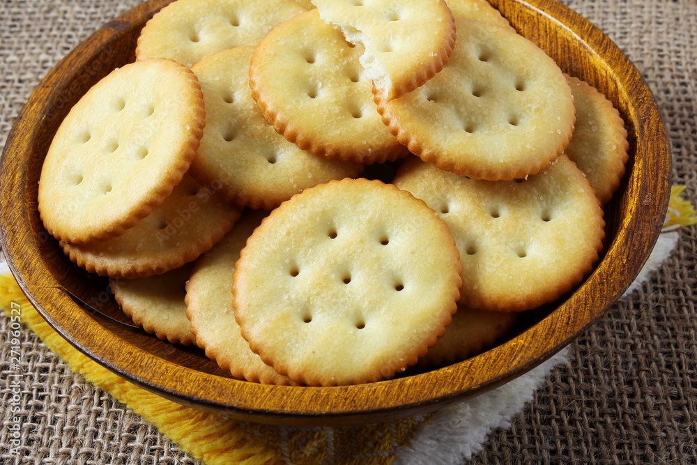 Top view of round salted snack cracker cookie isolated in bowl