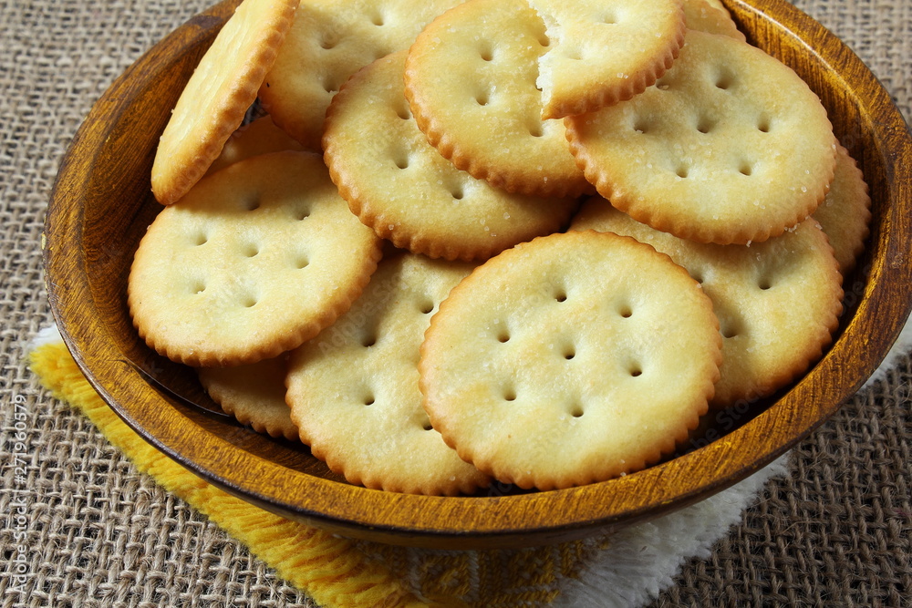 Top view of round salted snack cracker cookie isolated in bowl