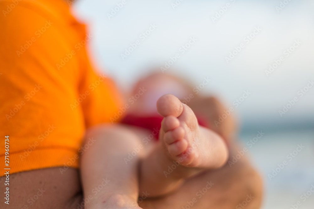 Baby foot in hands of father