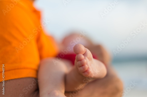 Baby foot in hands of father